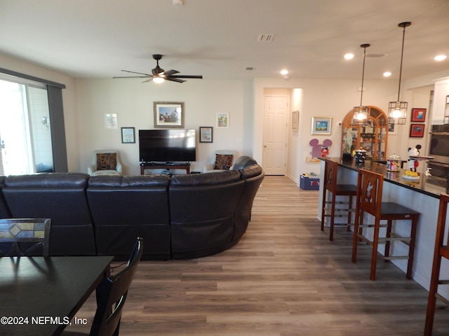 living room with hardwood / wood-style flooring and ceiling fan