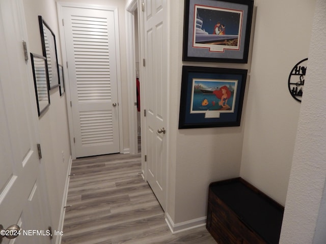 hallway with light hardwood / wood-style floors