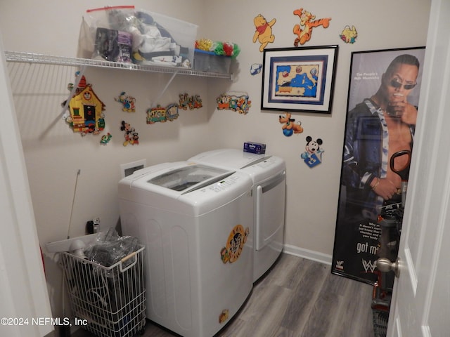 laundry area featuring wood-type flooring and separate washer and dryer