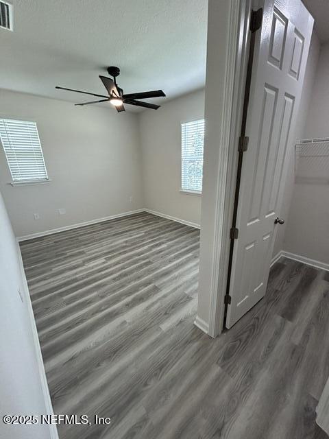 85431 Apple Canyon Ct, Fernandina Beach, FL 32034 - empty room with dark wood-type flooring and ceiling fan