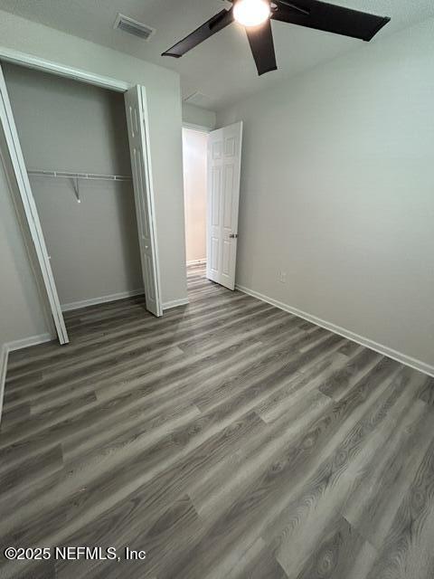 85431 Apple Canyon Ct, Fernandina Beach, FL 32034 - unfurnished bedroom featuring a closet, wood finished floors, and ceiling fan