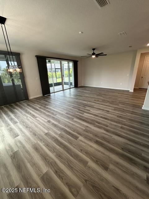 85431 Apple Canyon Ct, Fernandina Beach, FL 32034 - unfurnished living room featuring wood finished floors and ceiling fan