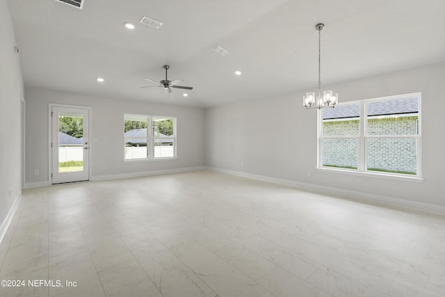 unfurnished room featuring ceiling fan with notable chandelier