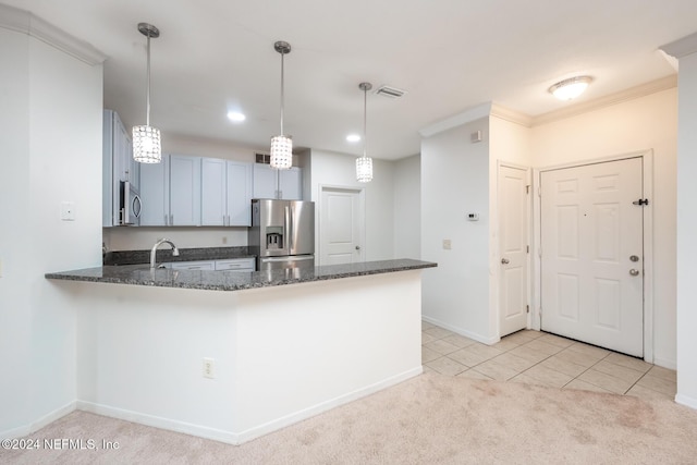 kitchen featuring kitchen peninsula, light carpet, hanging light fixtures, and stainless steel appliances