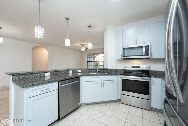 kitchen featuring white cabinetry, ceiling fan, pendant lighting, and appliances with stainless steel finishes