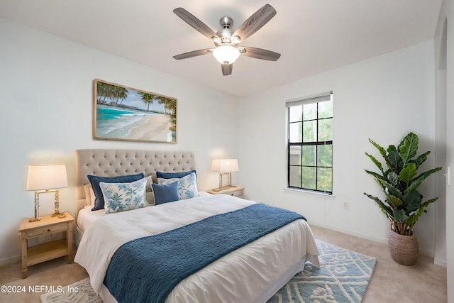 bedroom with ceiling fan and light colored carpet