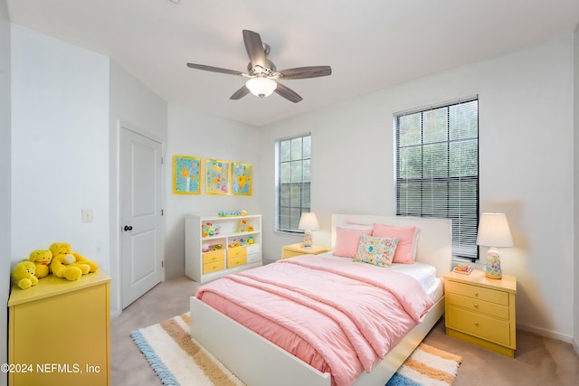 bedroom with ceiling fan and light carpet