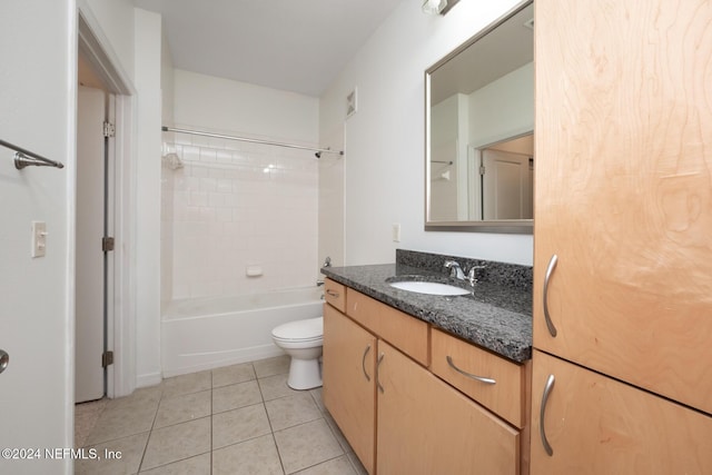 full bathroom featuring tile patterned flooring, vanity, toilet, and tiled shower / bath