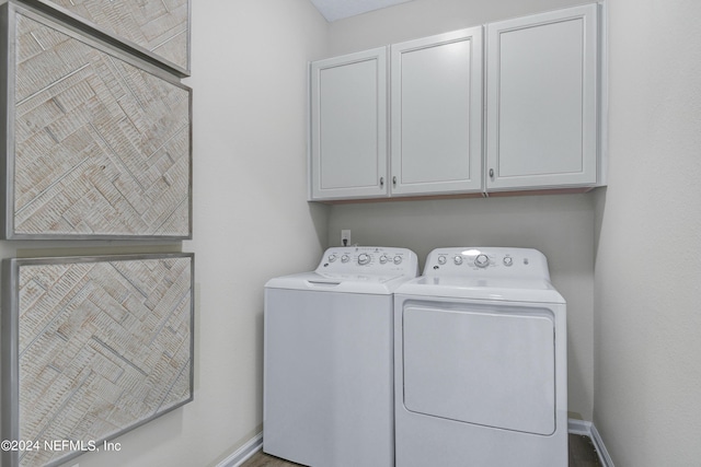 laundry room featuring cabinets and washing machine and clothes dryer