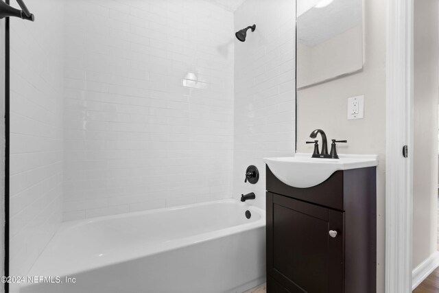 bathroom with vanity and tiled shower / bath combo