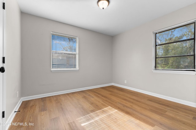 unfurnished room with wood-type flooring