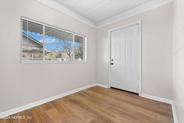 interior space with light hardwood / wood-style flooring, wood ceiling, and ornamental molding