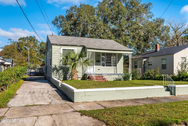 bungalow with a porch and a front yard