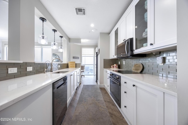 1431 Riverplace Blvd Unit 2105, Jacksonville, FL 32207 - kitchen with visible vents, a sink, black appliances, glass insert cabinets, and white cabinetry