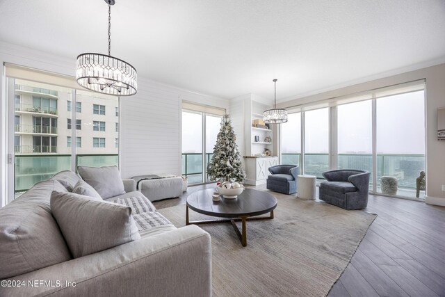 1431 Riverplace Blvd Unit 2105, Jacksonville, FL 32207 - living area featuring an inviting chandelier, wood finished floors, and a healthy amount of sunlight