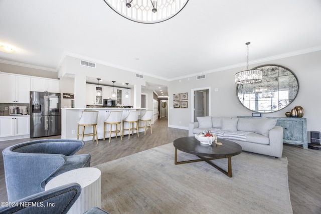 1431 Riverplace Blvd Unit 2105, Jacksonville, FL 32207 - living room with visible vents, a notable chandelier, and ornamental molding
