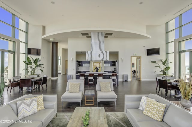 1431 Riverplace Blvd Unit 2105, Jacksonville, FL 32207 - living area with arched walkways, a wall of windows, a wealth of natural light, and wood finished floors
