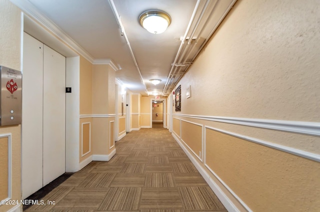 hall featuring elevator and ornamental molding