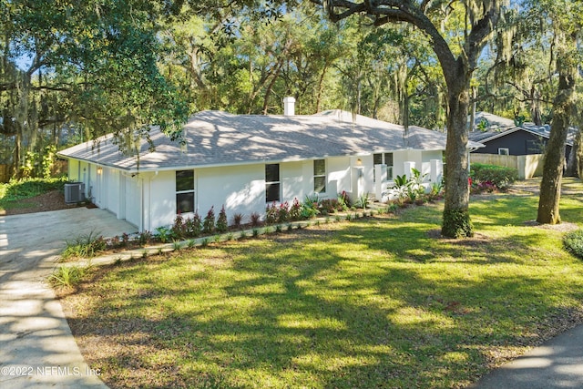 view of front of home with central air condition unit and a front yard