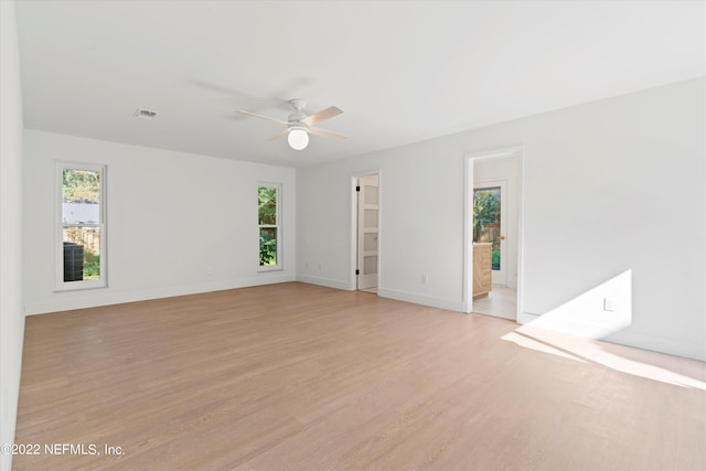 empty room featuring ceiling fan and light wood-type flooring