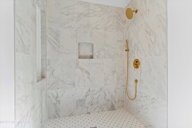 bathroom with tiled shower