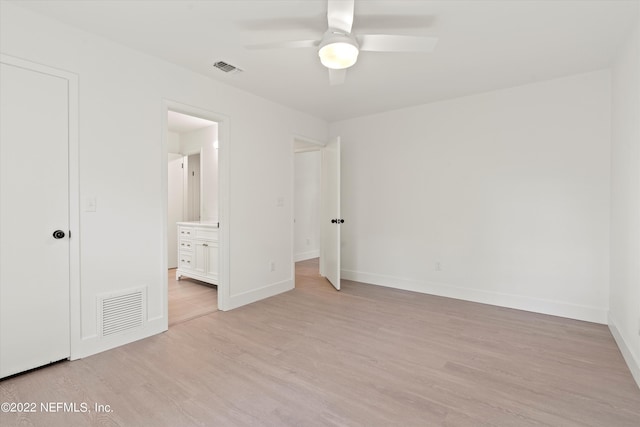 unfurnished bedroom featuring connected bathroom, light hardwood / wood-style floors, and ceiling fan