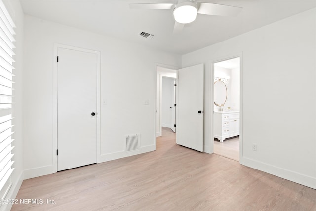 unfurnished bedroom with connected bathroom, a closet, light hardwood / wood-style flooring, and ceiling fan