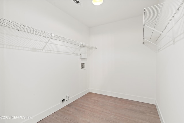 clothes washing area featuring hardwood / wood-style flooring, hookup for a gas dryer, and washer hookup