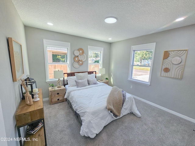 bedroom featuring carpet floors and a textured ceiling