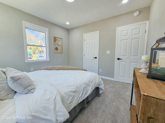 carpeted bedroom with a textured ceiling