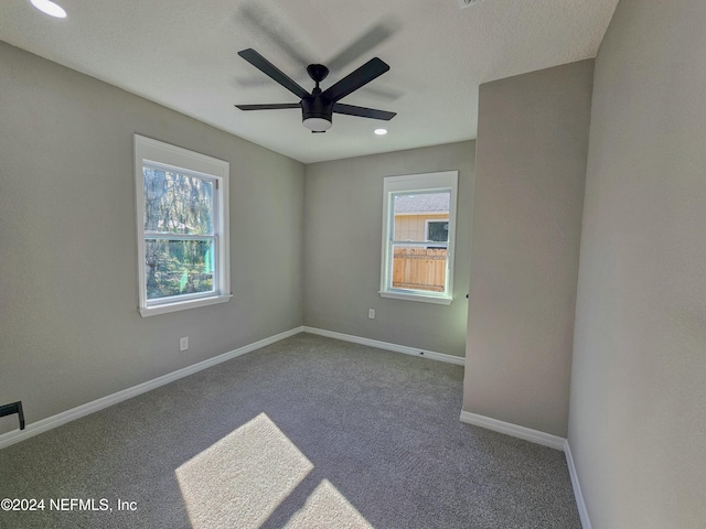 empty room featuring carpet flooring and ceiling fan