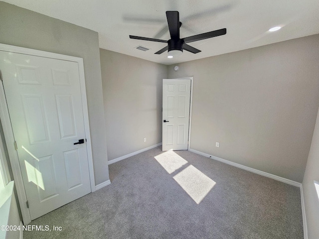 unfurnished bedroom with carpet flooring and ceiling fan