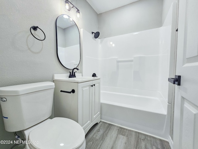 full bathroom with wood-type flooring, vanity, toilet, and shower / bathtub combination