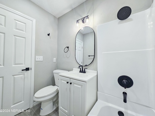 bathroom with vanity, wood-type flooring, a textured ceiling, and toilet