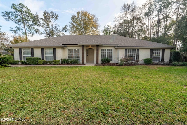 ranch-style home with a front yard