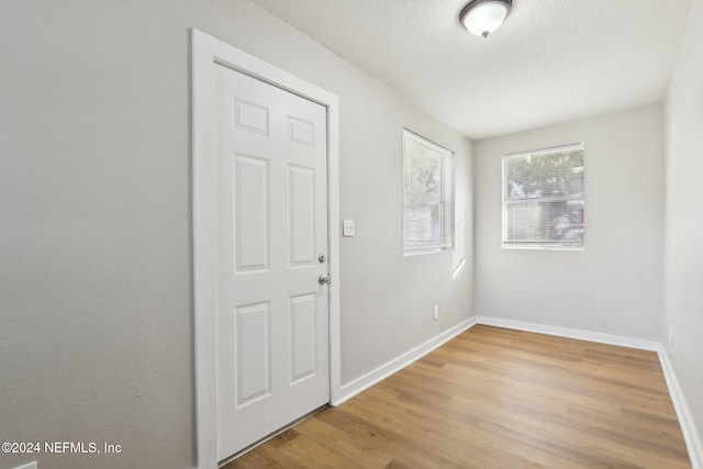 entryway featuring hardwood / wood-style floors and a textured ceiling