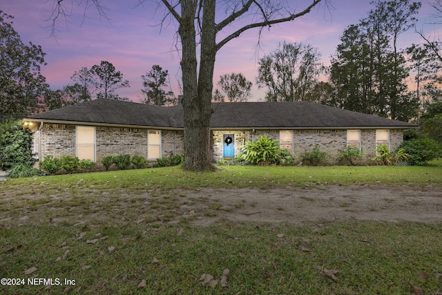 ranch-style house with a yard