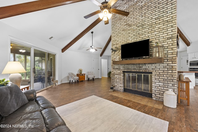 living room with beam ceiling, dark hardwood / wood-style flooring, high vaulted ceiling, and a brick fireplace