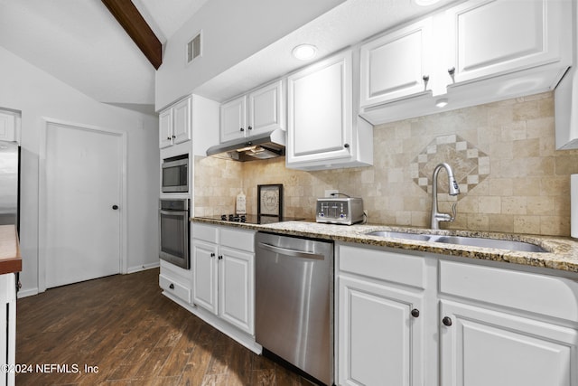 kitchen featuring white cabinets, vaulted ceiling with beams, and stainless steel appliances