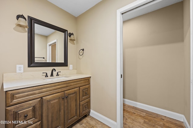 bathroom featuring hardwood / wood-style flooring and vanity