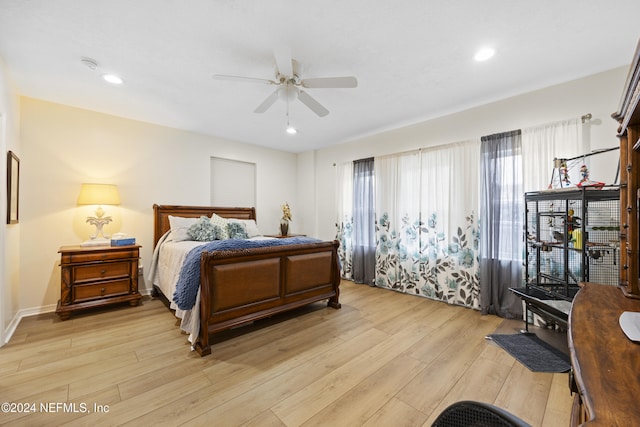 bedroom with ceiling fan and light hardwood / wood-style flooring