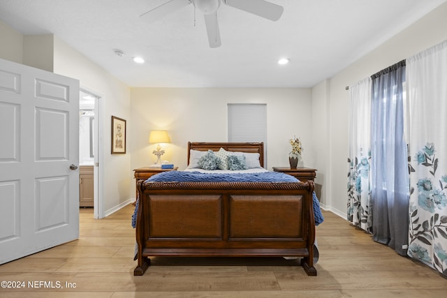 bedroom featuring ceiling fan, connected bathroom, and light hardwood / wood-style flooring