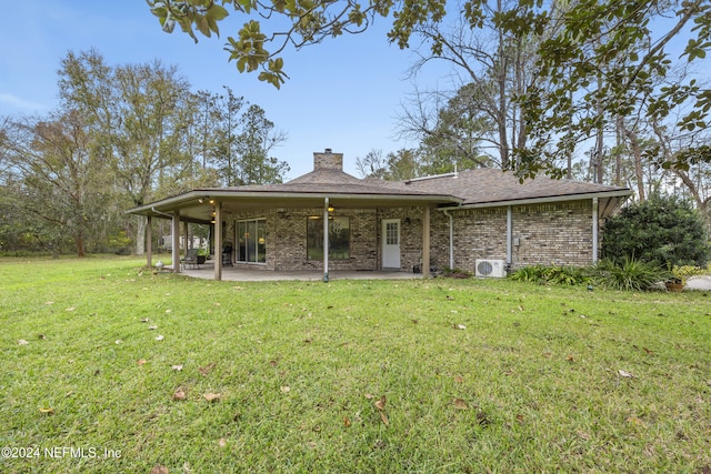 rear view of house featuring a lawn, ceiling fan, ac unit, and a patio