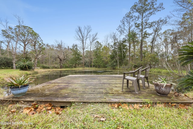 wooden terrace featuring a water view