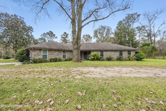 ranch-style home featuring a front yard