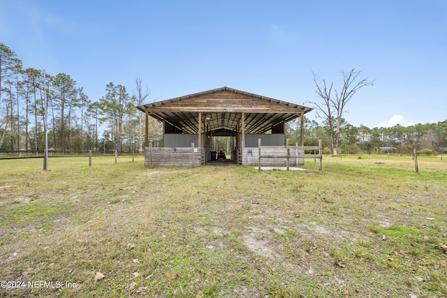 view of front facade featuring an outbuilding and a rural view