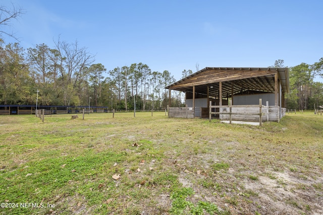 view of yard with a rural view and an outdoor structure