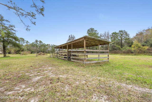 view of yard with a rural view and an outdoor structure