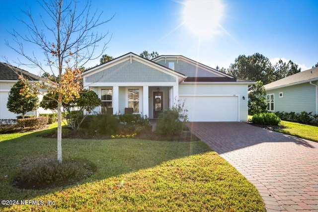 view of front of property featuring a porch, a front yard, and a garage