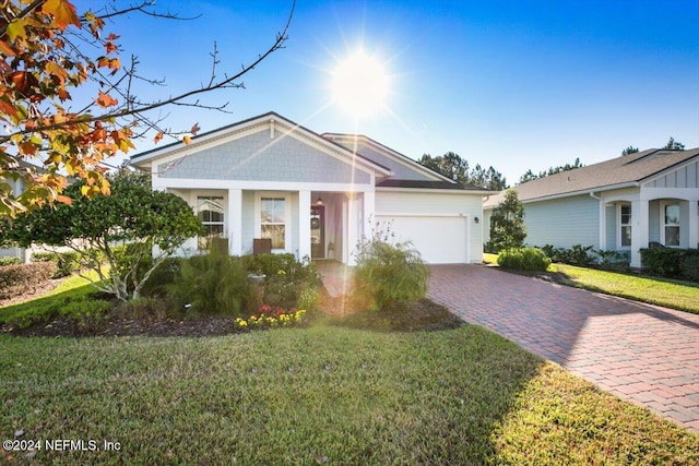 view of front of property featuring a garage and a front lawn